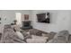 Comfortable living room showcasing a gray sectional sofa, fireplace, large television and neutral decor at 1174 E Belmont Ave, Phoenix, AZ 85020