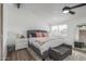 Bright main bedroom features a ceiling fan, large window, king bed, ensuite bathroom, and walk in closet at 1174 E Belmont Ave, Phoenix, AZ 85020
