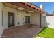 Covered patio with a concrete slab, skylights, ceiling fan, a small seating area and artificial grass at 1174 E Belmont Ave, Phoenix, AZ 85020