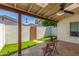 Relaxing covered patio with a stone floor, artificial turf and a table set for two at 1174 E Belmont Ave, Phoenix, AZ 85020