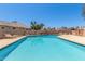 Inviting community pool featuring lounge chairs, clear water, and a well-maintained deck at 1174 E Belmont Ave, Phoenix, AZ 85020