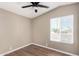 Bedroom with a ceiling fan, neutral paint, wood-look floors, and a window at 12811 N 19Th Pl, Phoenix, AZ 85022