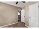 Neutral bedroom featuring wood look floors, a ceiling fan, and view into adjacent room with octagon window at 12811 N 19Th Pl, Phoenix, AZ 85022