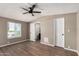 Spacious bedroom with wood-look flooring, a ceiling fan, and natural light at 12811 N 19Th Pl, Phoenix, AZ 85022