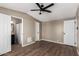 Well-lit bedroom with wood-look flooring, a ceiling fan, and a connecting bathroom at 12811 N 19Th Pl, Phoenix, AZ 85022