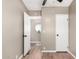 Neutral bedroom featuring wood look floors, a ceiling fan, and view into adjacent room with octagon window at 12811 N 19Th Pl, Phoenix, AZ 85022