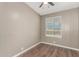 Cozy bedroom features wood-look vinyl floors, a window with blinds and a ceiling fan at 12811 N 19Th Pl, Phoenix, AZ 85022