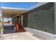 Exterior view of a home with a convenient carport and desert-style landscaping for simplified upkeep at 12811 N 19Th Pl, Phoenix, AZ 85022