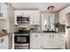 Well-equipped kitchen with stainless steel appliances and light countertops at 12811 N 19Th Pl, Phoenix, AZ 85022