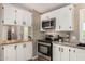 Modern kitchen with stainless steel appliances, light countertops, and wood accents at 12811 N 19Th Pl, Phoenix, AZ 85022