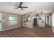 Inviting living area showcasing open concept layout with modern ceiling fan and light fixtures at 12811 N 19Th Pl, Phoenix, AZ 85022