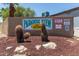Entrance sign for a community with desert landscaping, neighborhood name and contact information at 12811 N 19Th Pl, Phoenix, AZ 85022