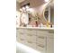 Elegant bathroom featuring double sinks, round mirrors, and ample counter space at 136 E Vera Ln, Tempe, AZ 85284
