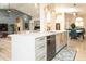 Open concept kitchen with island, white cabinets, stainless steel appliances, and hardwood floors at 136 E Vera Ln, Tempe, AZ 85284