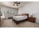 Bright bedroom with neutral carpet, ceiling fan, and two large windows at 16800 E El Lago Blvd # 2076, Fountain Hills, AZ 85268