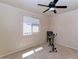 Neutral bedroom features a ceiling fan and plenty of sunlight at 1711 W Houston Ave, Gilbert, AZ 85233