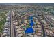 Wide aerial view of a community with multiple ponds surrounded by homes, streets, and green spaces at 1741 S Clearview Ave # 13, Mesa, AZ 85209