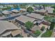 Community aerial view featuring well-maintained homes with desert landscaping, tile roofs, and community lake at 1741 S Clearview Ave # 13, Mesa, AZ 85209