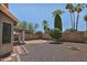 Backyard with gravel landscaping, block wall and mature trees at 1741 S Clearview Ave # 13, Mesa, AZ 85209