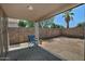 Backyard covered patio with seating area and desert landscaping at 1741 S Clearview Ave # 13, Mesa, AZ 85209