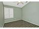 Green bedroom with wood-look tile flooring and white window shutters at 1741 S Clearview Ave # 13, Mesa, AZ 85209