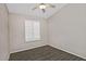 This bedroom has a ceiling fan, window with shutters and wood-look tile flooring at 1741 S Clearview Ave # 13, Mesa, AZ 85209