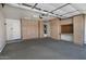 Organized garage featuring storage cabinets and workspace area at 1741 S Clearview Ave # 13, Mesa, AZ 85209