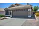A home exterior featuring a two-car garage, desert landscaping, tile roofing, and a concrete driveway at 1741 S Clearview Ave # 13, Mesa, AZ 85209
