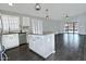 Open-concept kitchen featuring white cabinets, granite countertops, stainless steel appliances, and wood-look tile flooring at 1741 S Clearview Ave # 13, Mesa, AZ 85209