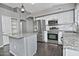 Well-lit kitchen with white cabinets, granite countertops, stainless steel appliances, and wood-look tile flooring at 1741 S Clearview Ave # 13, Mesa, AZ 85209
