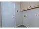Functional laundry area includes overhead cabinets and utility connections at 1741 S Clearview Ave # 13, Mesa, AZ 85209