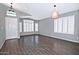 A spacious living room with wood-look tile flooring, white plantation shutters, and modern light fixtures at 1741 S Clearview Ave # 13, Mesa, AZ 85209