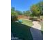 Landscaped backyard with artificial turf and a curved walkway offering a serene outdoor space at 2018 W Marconi Ave, Phoenix, AZ 85023