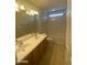 Well-lit bathroom features a double sink vanity, bathtub, and tile flooring for a modern touch at 2018 W Marconi Ave, Phoenix, AZ 85023