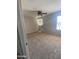 Spacious bedroom featuring neutral-toned walls, plush carpet, and a ceiling fan for comfortable living at 2018 W Marconi Ave, Phoenix, AZ 85023