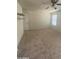 Bright bedroom features neutral walls, plush carpeting, a ceiling fan, and natural light, creating a cozy atmosphere at 2018 W Marconi Ave, Phoenix, AZ 85023