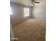 Inviting bedroom with carpet, ceiling fan, and two windows offering ample natural light at 2018 W Marconi Ave, Phoenix, AZ 85023