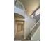 Inviting entryway featuring a staircase with white railings, carpeted steps, and neutral walls at 2018 W Marconi Ave, Phoenix, AZ 85023