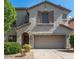 Charming two-story home featuring a stucco exterior, well-manicured landscaping, and an attached two-car garage at 2018 W Marconi Ave, Phoenix, AZ 85023