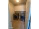Functional laundry room with tile floors, washer, dryer, and overhead cabinets for storage at 2018 W Marconi Ave, Phoenix, AZ 85023
