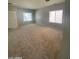 Bright and airy living room featuring plush carpeting, neutral walls, and multiple windows for natural light at 2018 W Marconi Ave, Phoenix, AZ 85023