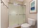Bathroom featuring a modern glass shower and toilet with wood-look vinyl floors at 20801 N 90Th Pl # 255, Scottsdale, AZ 85255