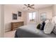 This main bedroom includes a window, dresser, stylish decor, and calming natural light at 20801 N 90Th Pl # 255, Scottsdale, AZ 85255