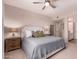 This is a primary bedroom with a ceiling fan, wood night stands, and an attached bathroom at 20801 N 90Th Pl # 255, Scottsdale, AZ 85255