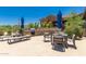 Community barbecue area with tables, lounge chairs, and umbrellas for shade at 20801 N 90Th Pl # 255, Scottsdale, AZ 85255