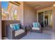 Cozy covered patio area with comfortable seating and a stylish blue patterned rug at 20801 N 90Th Pl # 255, Scottsdale, AZ 85255