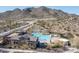 Beautiful community pool with lounge chairs and seating, set against a mountain backdrop at 21297 W Edgemont Ave, Buckeye, AZ 85396