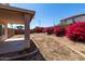 Private backyard with gravel, flowers, and covered patio, perfect for outdoor relaxation at 22322 W Loma Linda Cir, Buckeye, AZ 85326