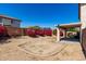 Spacious backyard featuring desert landscaping and a covered patio at 22322 W Loma Linda Cir, Buckeye, AZ 85326