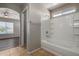 Bathroom featuring a tub and shower combo and an archway entrance to the bedroom at 22322 W Loma Linda Cir, Buckeye, AZ 85326
